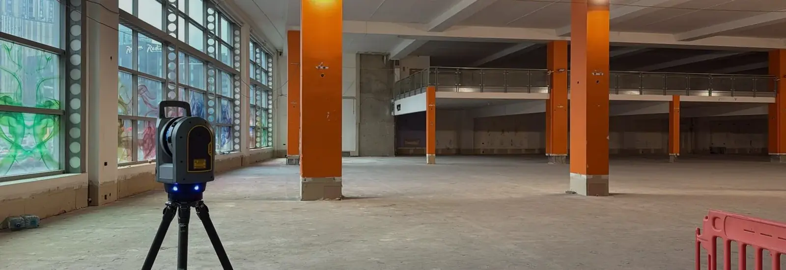 Laser scanner set up on a stripped commercial floor plate